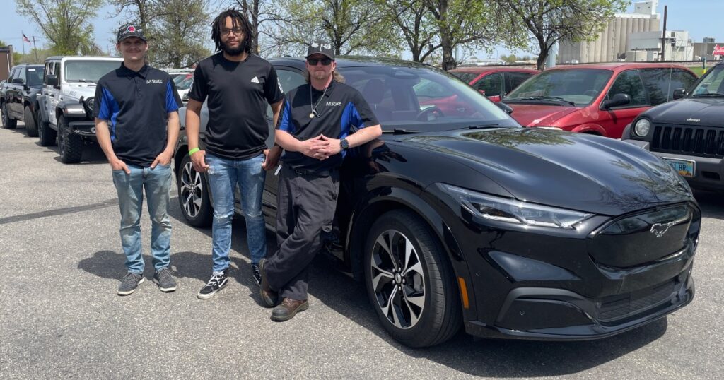 Three REACH team members at a test drive in Moorhead, Minnesota